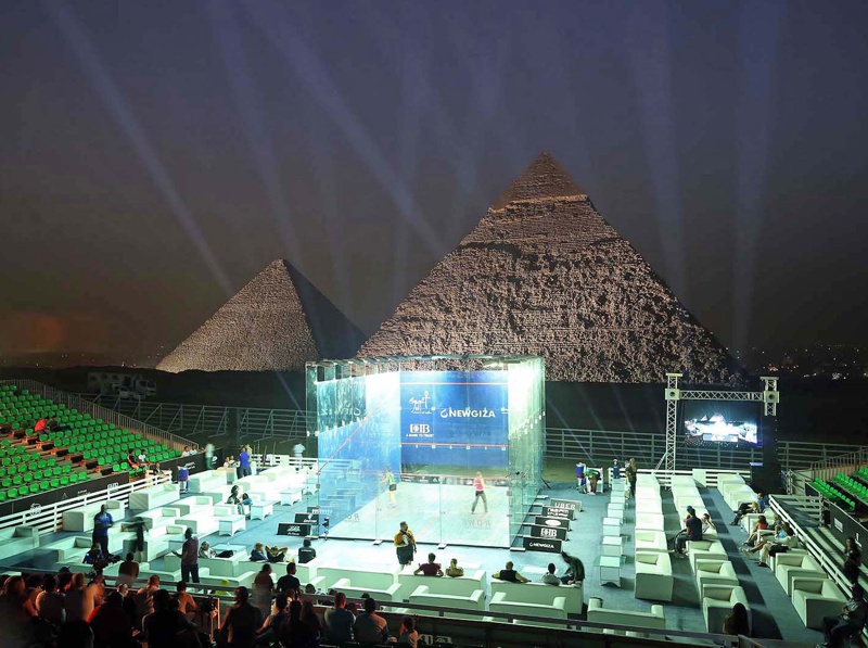 Court with pyramids in background